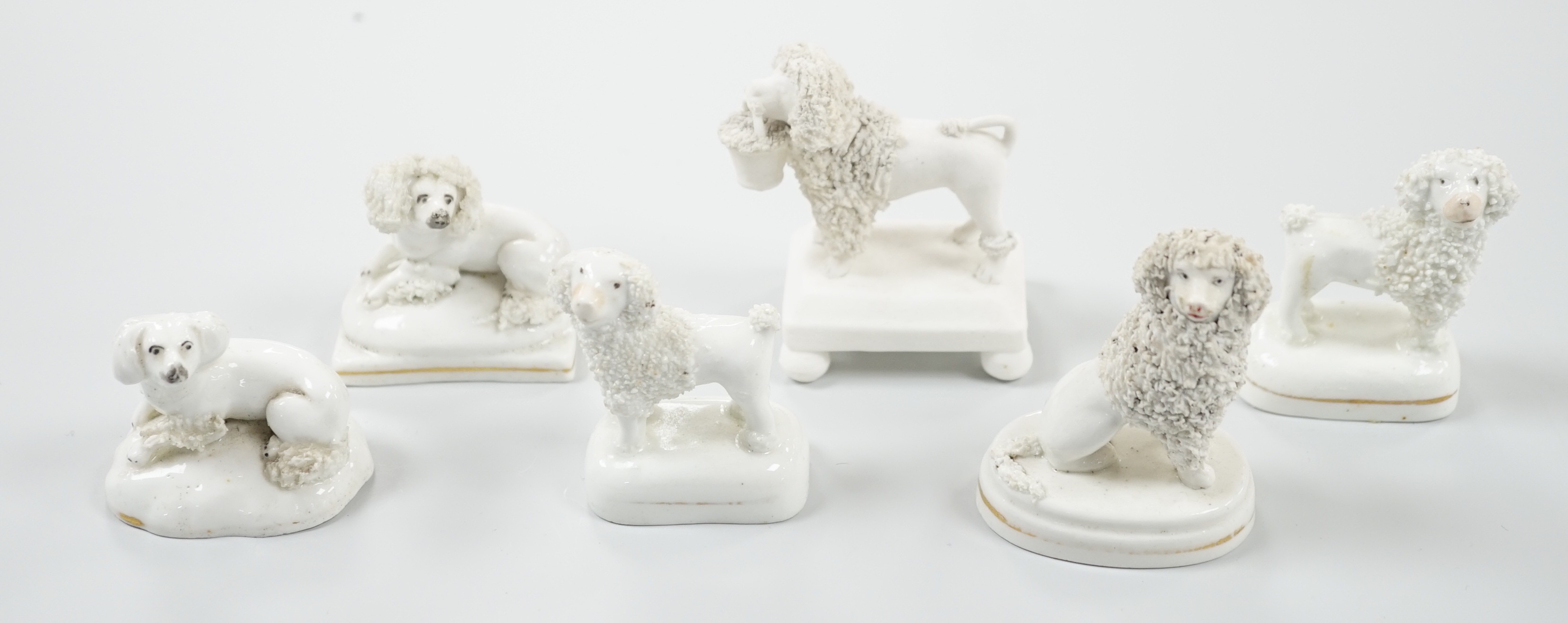 Five small Staffordshire models of poodles, together with a small poodle lying recumbent on an oval mounted base, possibly Davenport, c.1830-50, (6). Tallest 6.8cm., Provence: Dennis G. Rice collection, Cf. Dennis G.Rice